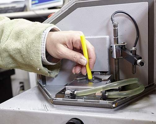 A picture of a technician testing steel quality.